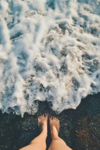 Feet near inland seashore.