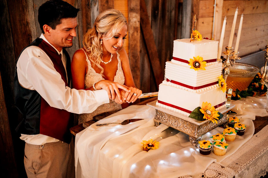 newlywed couple cut the cake